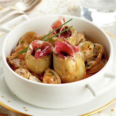 Plato de alcachofas con almejas y jamón servido