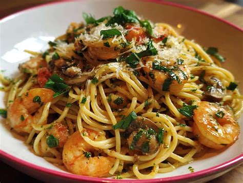 Plato de espaguetis con setas y gambas recién servido