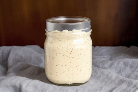 Imagen de un frasco de mayonesa casera con ingredientes frescos