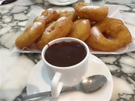 Surtido de churros, porras y buñuelos con chocolate caliente