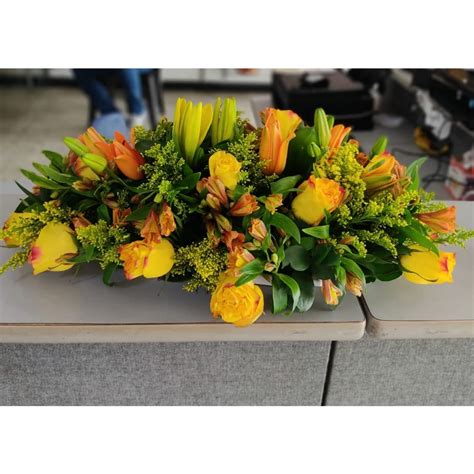 Centro de mesa con flores y verduras variadas