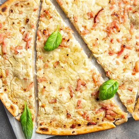 Flammkuchen tradicional con crema agria, cebolla y bacon