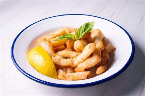 Plato de pescado rebozado servido con limón decorado