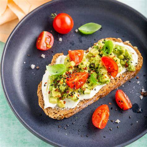 Tostada de aguacate y queso crema con tomates cherry