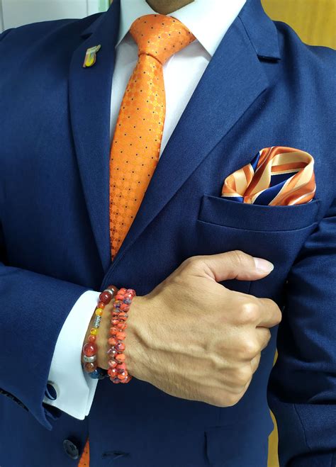 Hombre con corbata naranja y blazer azul claro en una cena informal