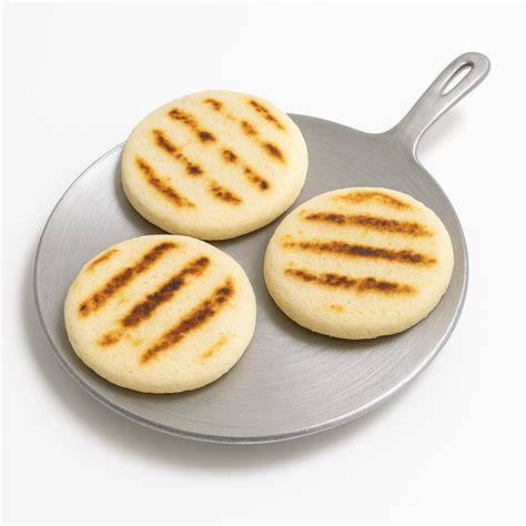 Utensilios tradicionales para cocinar arepas: budare y tostiarepas