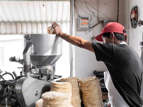 Proceso de aplanado de tortillas con prensa