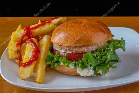 Hamburguesa de salmón y merluza servida con ensalada y pan
