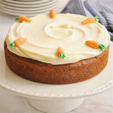 Carrot cake recién decorada con frosting de queso y nueces