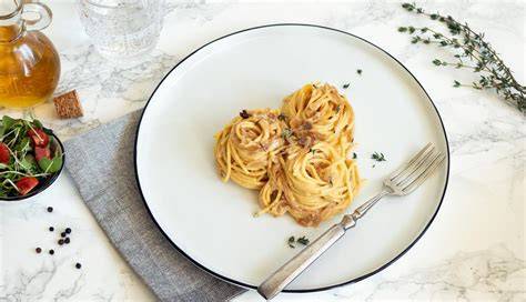 Plato de spaghetti con salsa cremosa de nueces y trozos de nuez espolvoreados