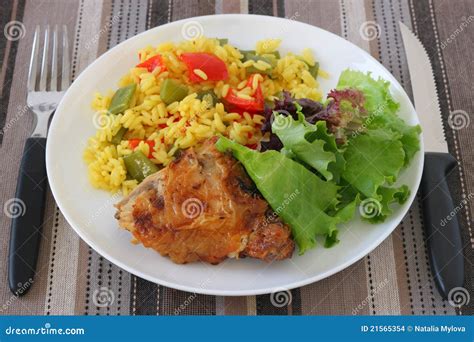 Plato de pollo adobado frito con arroz y ensalada