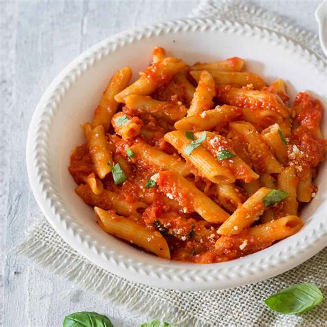 Plato de pasta cocida con salsa de tomate y verduras