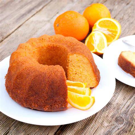 Bizcocho de avena, yogur y naranja decorado con rodajas de naranja y azúcar glas