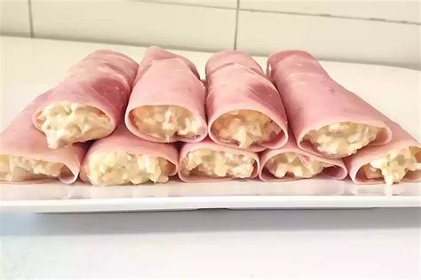 preparación de los rollitos de jamón colocando el espagueti sobre la rebanada