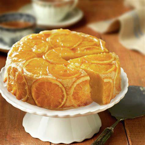 Tarta de naranja recién horneada con glaseado y rodajas de naranja