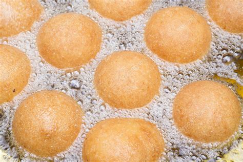 Buñuelos colombianos friéndose en aceite caliente