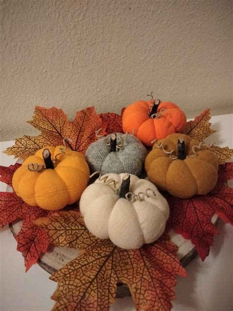 calabazas decorativas hechas con calcetines y arroz sobre una mesa de madera