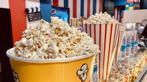 Un mostrador de cine con palomitas, bebidas y dulces