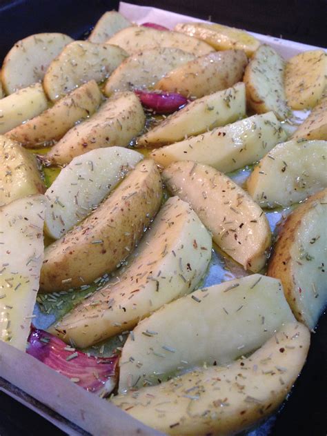 Patatas cortadas en gajos en una bandeja de horno