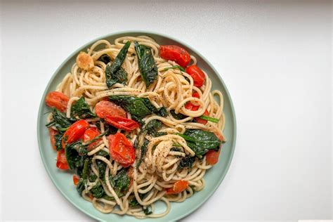 Ingredientes frescos para espaguetis con espinacas: espaguetis, espinacas frescas, ajo, tomates cherry