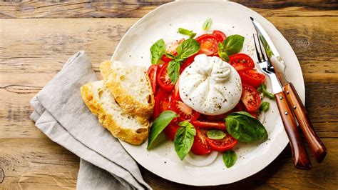 Bruschetta terminada con burrata y tomates