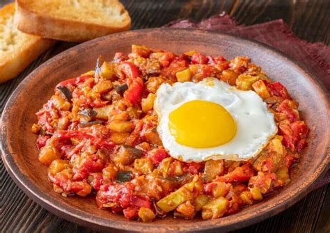 Plato de pisto de verduras con huevos cuajados encima