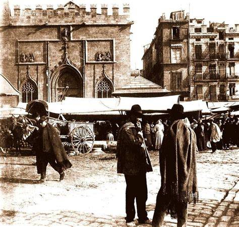 Fotografía antigua de la plaza España de Archena con un puesto de carnes y embutidos