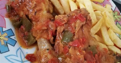 Pollo al chilindrón emplatado con patatas fritas