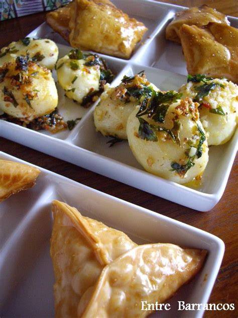 Empanadillas variadas sobre un plato, con una gaseosa fresca al lado