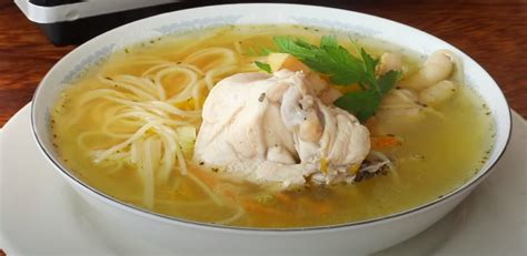 Plato de sopa de pollo con lima y cacahuetes servida