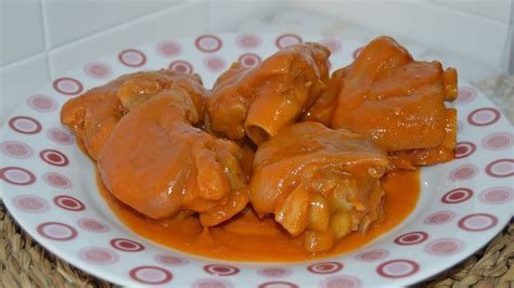 Plato servido de manitas de cerdo en salsa de pimiento choricero