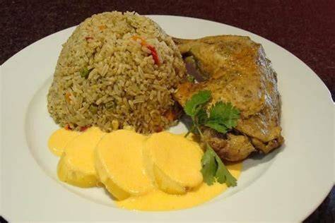 Arroz con pollo con papa a la huancaína y salsa criolla