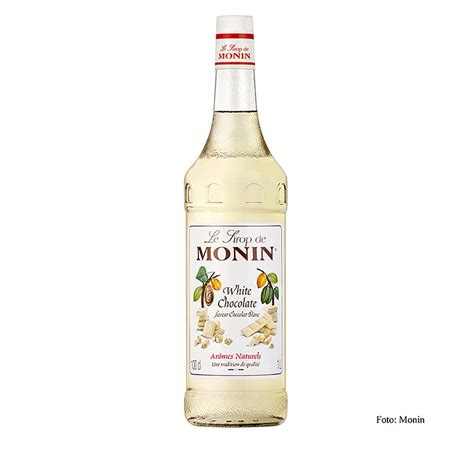 Botella de sirope de chocolate blanco sobre una pila de crepes