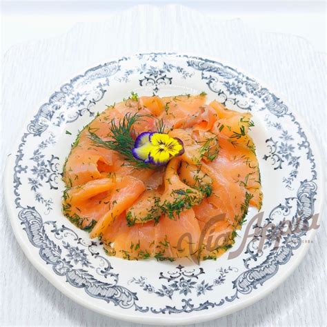 Plato de gravlax servido con eneldo y limón