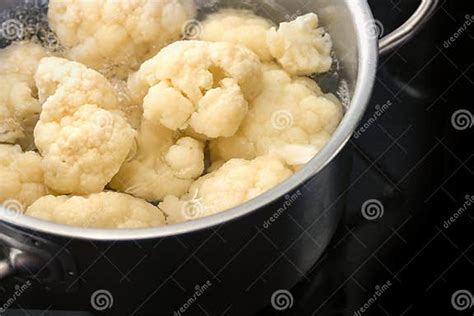 Coliflor y patatas hirviendo en cacerola